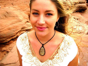 model wearing brown striped tear drop shaped aragonite gemstone necklace