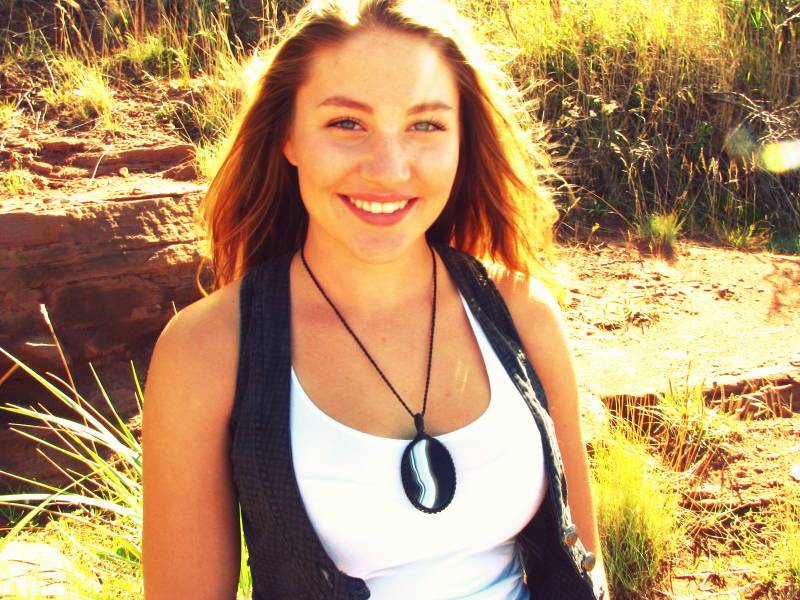 woman wearing macrame gemstone necklace