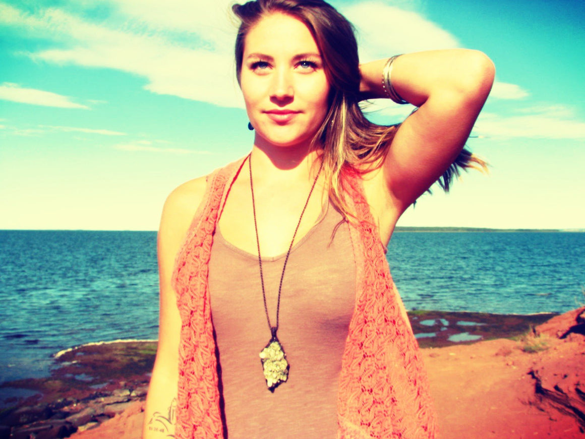 woman wearing crystal healing necklace