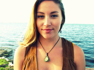 model wearing a green peridot necklace