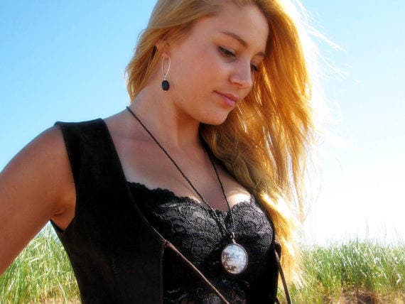 Model is wearing a circle shaped Crazy Lace Agate pendant necklace, crazy lace macrame necklace