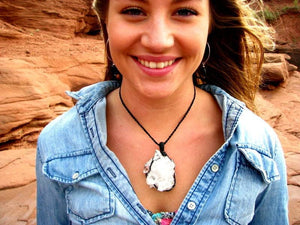 Model is wearing a chunky Arkansas Quartz crystal necklace, several large crystal points and several smaller ones
