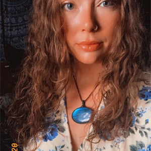 Model is wearing a blue oval shaped Labradorite necklace, boho style necklace, macrame necklace